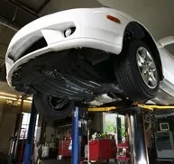 White Car on a Lift, MOTs in Salford, Lancashire